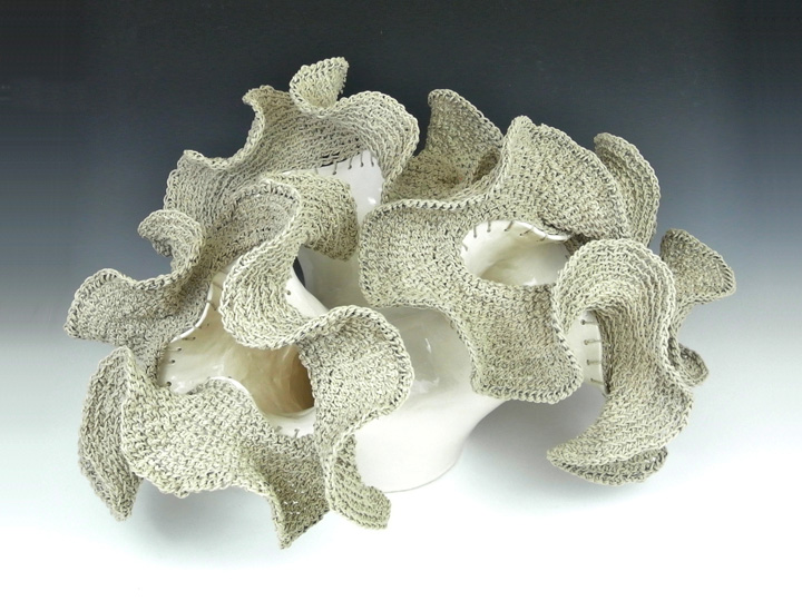 Mathematical sculpture mixing ceramics and hyperbolic knitting.